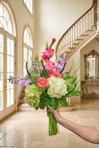 Blush Life Bouquet held in a bright entryway - Garrett Florist